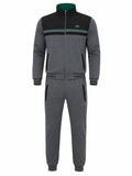A two-piece tracksuit set consisting of a zip-up jacket and matching jogger pants in heather gray, with black color-blocked panels on the jacket, a green inner collar, and a small Lacoste crocodile logo on the chest and thigh.