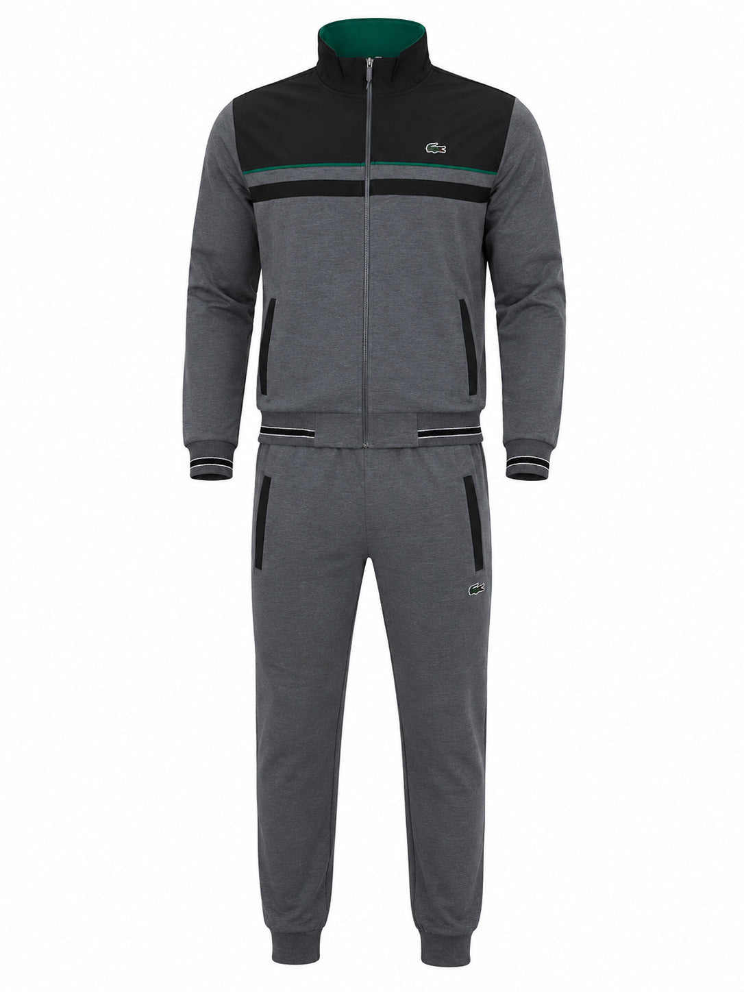 A two-piece tracksuit set consisting of a zip-up jacket and matching jogger pants in heather gray, with black color-blocked panels on the jacket, a green inner collar, and a small Lacoste crocodile logo on the chest and thigh.