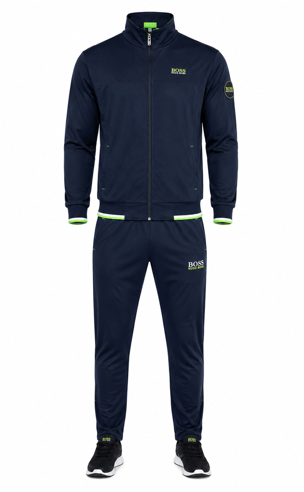 A navy blue two-piece tracksuit set from Hugo Boss, featuring a zip-up jacket and matching pants, with lime green accents on the cuffs, hem, and logo details, shown on a white background.